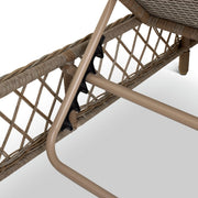 Woven rattan chair with beige metal frame and black connectors, luxury outdoor furniture detail