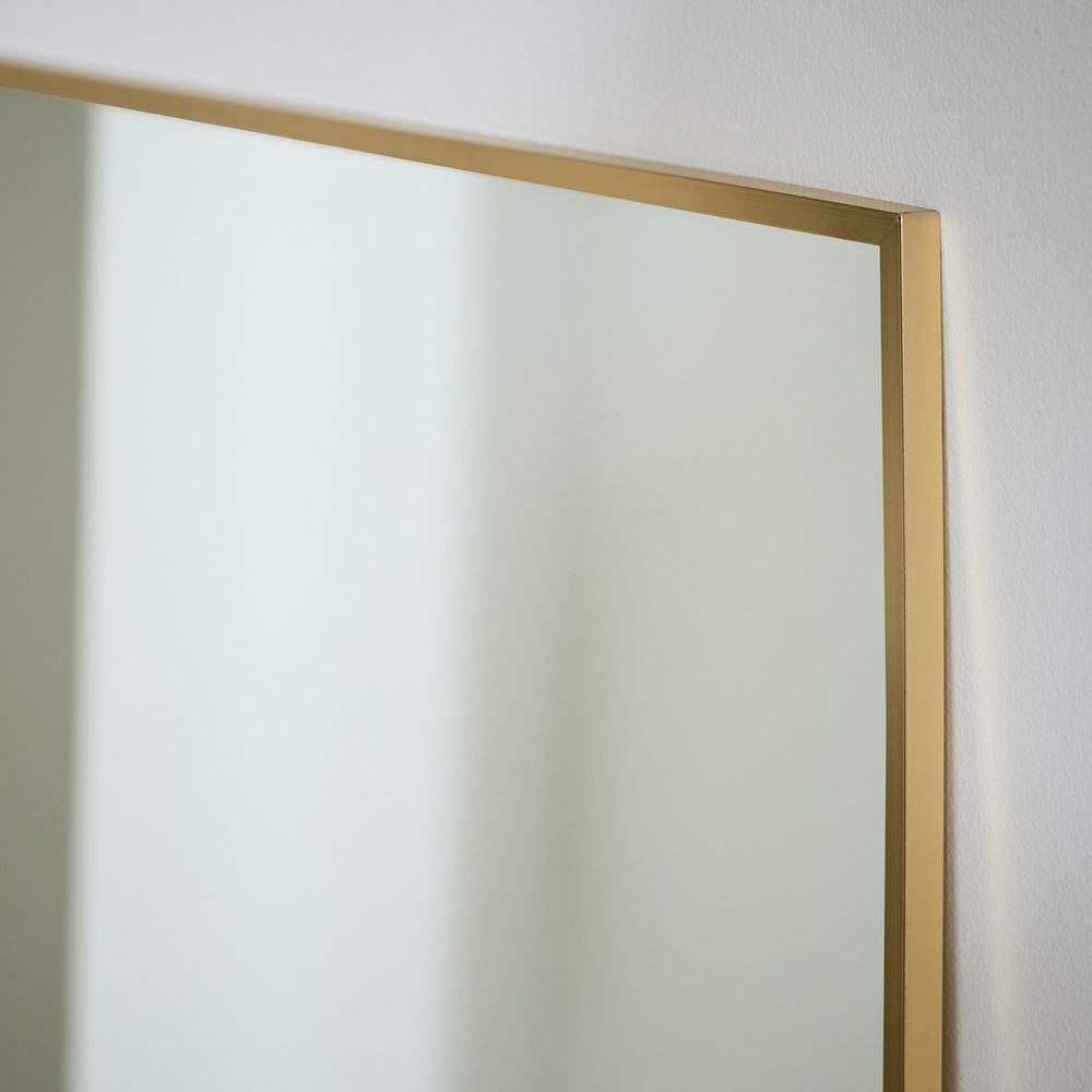 Gold-framed wall mirror with sleek modern design for luxury home decor