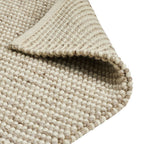 Textured beige woven rug with chunky loop pile, ideal for luxury living room decor
