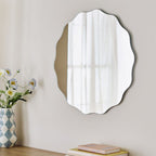 Scalloped edge wall mirror with floral vase and books, modern home decor