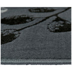 Grey area rug with black floral pattern, soft textured pile and stitched edge for modern living rooms