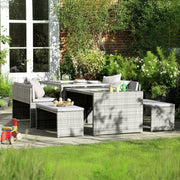 Grey wicker outdoor dining set with cushions on patio, perfect for garden entertaining