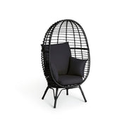Black wicker egg chair with plush cushions, modern outdoor seating for luxury living spaces