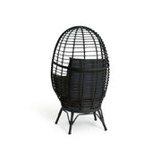 Black egg-shaped wicker chair with cushion, modern lounge seating for luxury living spaces