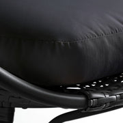 Black woven rattan chair with plush cushion, modern outdoor seating