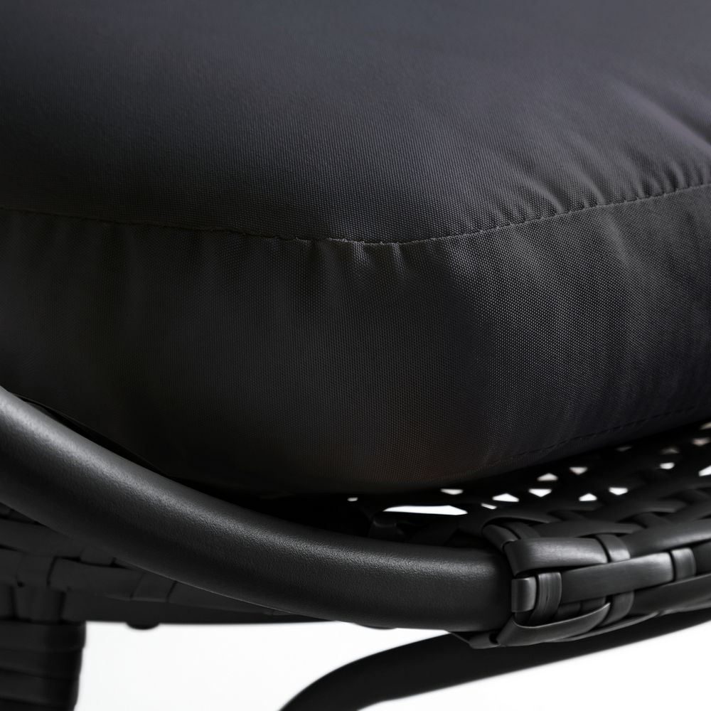 Black woven rattan chair with plush cushion, modern outdoor seating
