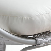 Cream cushion on woven grey rattan chair, luxury sofa bedding detail