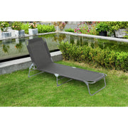 Grey outdoor lounge chair on grass by poolside garden