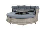 Circular outdoor wicker sofa with grey cushions and central table, perfect for garden lounging