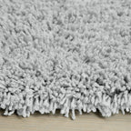 Soft grey shaggy rug on wooden floor, cozy luxury home decor
