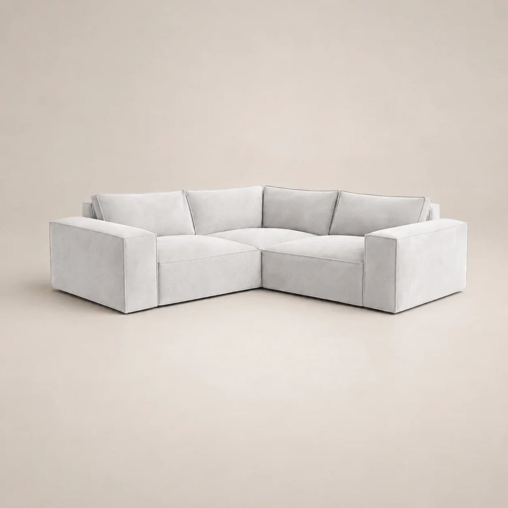 Modern light grey L-shaped sectional sofa with plush cushions, ideal for luxury living rooms