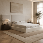 Luxury beige upholstered bed with modern headboard, bedside tables, and ambient lighting in neutral bedroom
