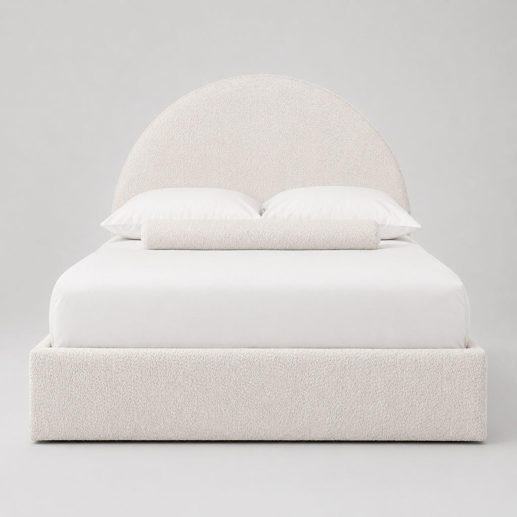 Luxury upholstered bed with curved headboard, white bedding, and textured fabric for modern bedroom