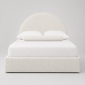 Luxury upholstered bed with curved headboard, white bedding, and textured fabric for modern bedroom