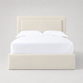 Cream upholstered bed frame with white linens, modern luxury bedroom furniture