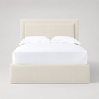 Cream upholstered bed frame with white linens, modern luxury bedroom furniture