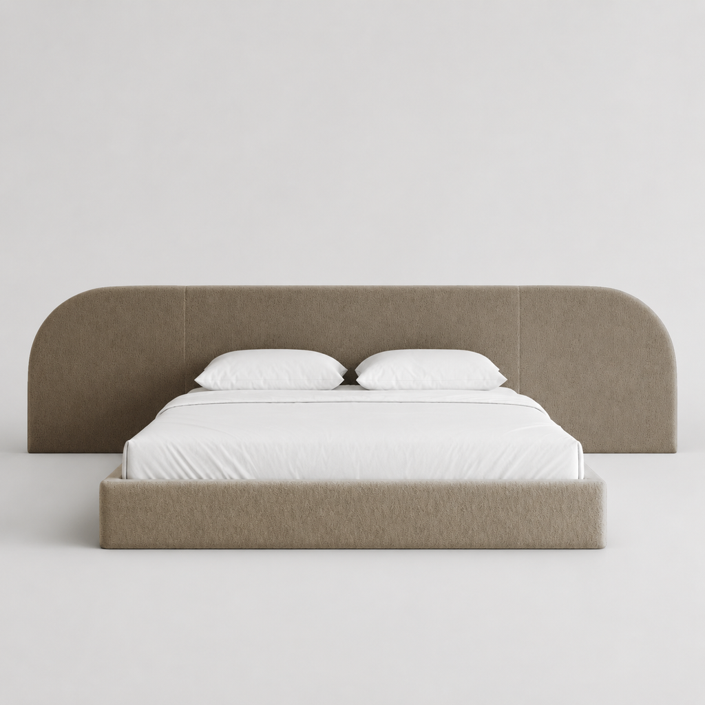 Modern upholstered bed with curved headboard, white linens, luxury bedroom furniture
