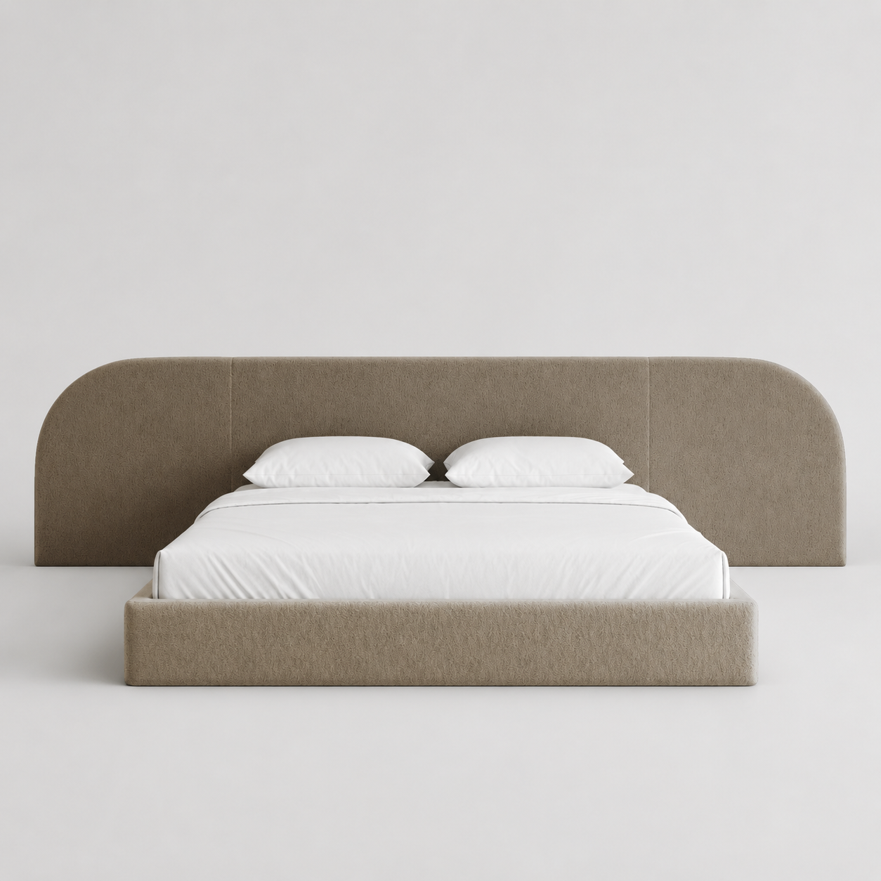 Modern upholstered bed with curved headboard, white linens, luxury bedroom furniture