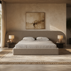 Luxury upholstered bed with curved headboard in modern bedroom, neutral tones, bedside lamps, and abstract art