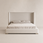 Luxury upholstered bed with wingback headboard, neutral tones, modern bedroom furniture