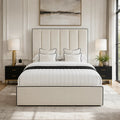 Luxury cream upholstered bed with black trim, white bedding, and modern nightstands in elegant bedroom