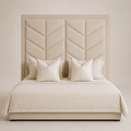 Luxury beige upholstered bed with geometric chevron headboard and matching pillows, perfect for modern bedrooms.