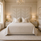 Luxury beige bed with chevron headboard, matching nightstands, and elegant chandelier in serene bedroom