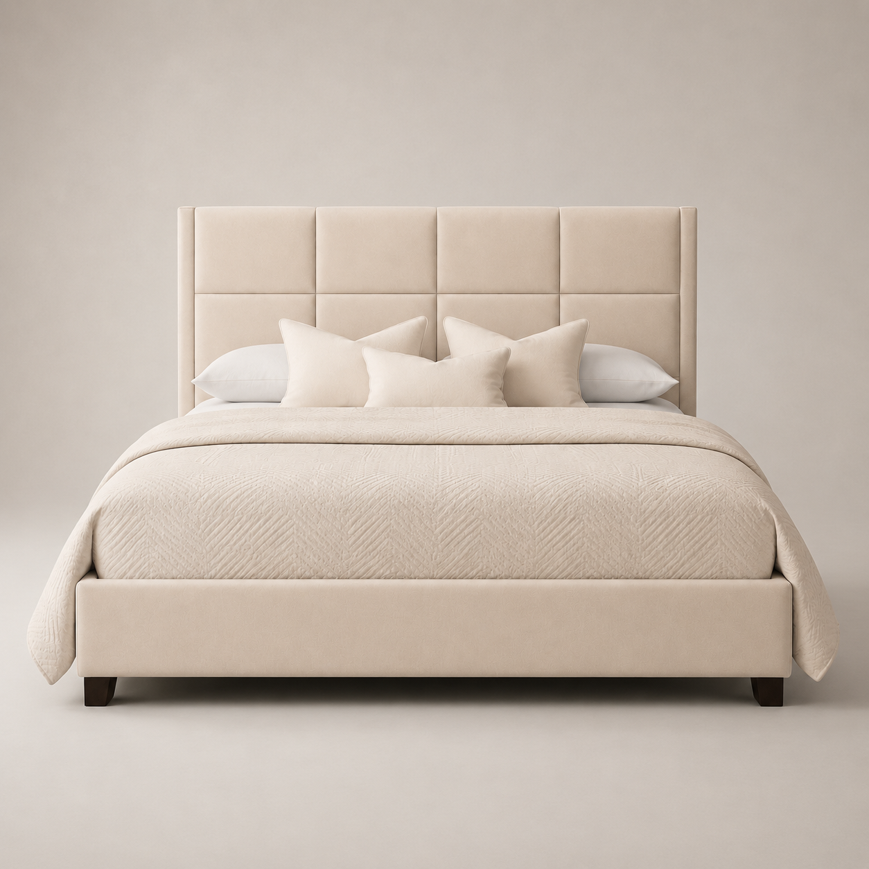 Luxury beige upholstered bed with tufted headboard, neutral bedding, and dark wood legs