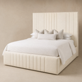 Luxury cream upholstered bed with tufted headboard and base, styled with white bedding and pillows