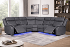 Modern grey leather corner sofa with recliners and blue LED lighting in a stylish living room