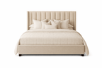 Beige upholstered bed with vertical panel headboard and decorative pillows