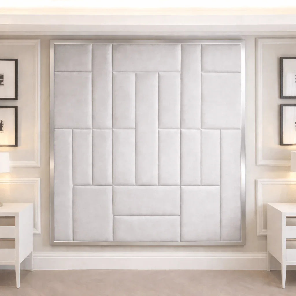 Modern bedroom with large upholstered panel headboard, white nightstands, and wall art