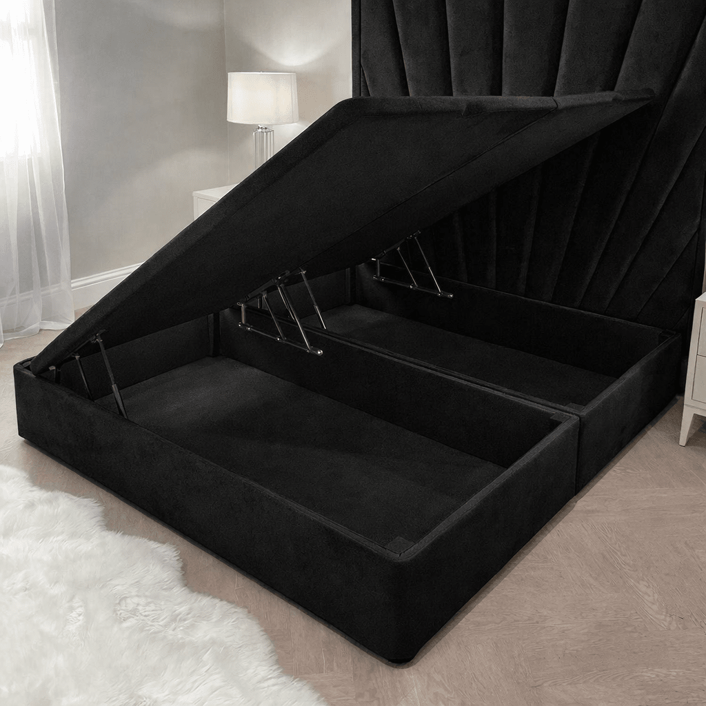 Black velvet ottoman storage bed with open lift-up base in a modern bedroom