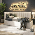 Modern upholstered bed with plush pillows and throw blanket in a stylish bedroom setting