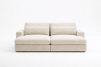 Modern beige fabric sofa with wide cushions and armrests on a white background