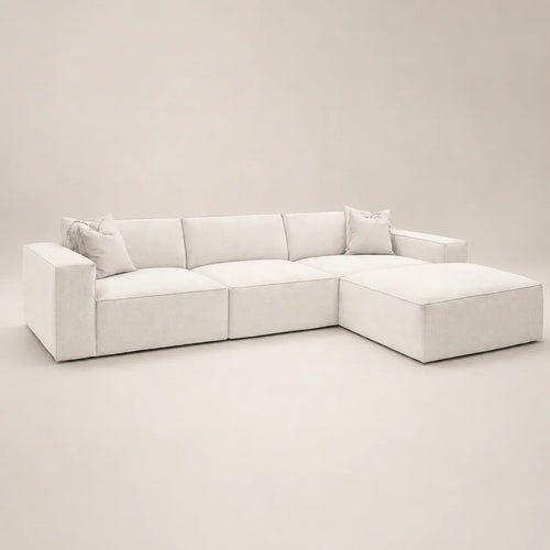 Luxury white sectional sofa with chaise and plush cushions, modern minimalist design