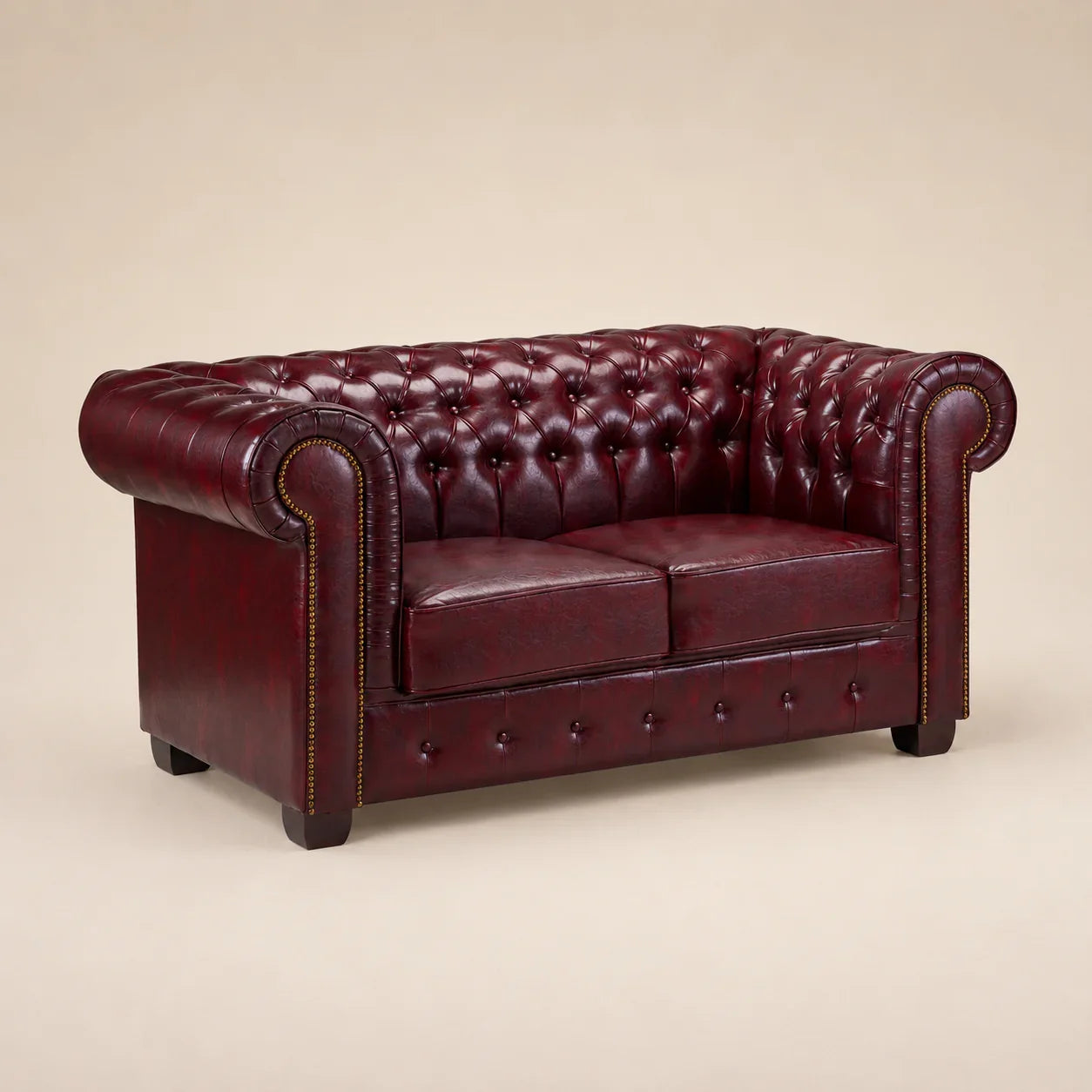 Luxury burgundy leather Chesterfield sofa with tufted back and rolled arms, ideal for elegant living rooms.