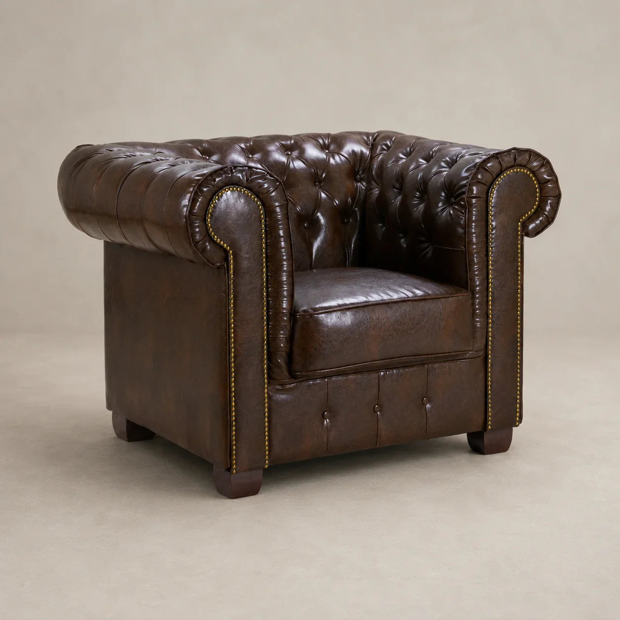 Luxury brown leather Chesterfield armchair with tufted back and rolled arms, ideal for living room comfort.