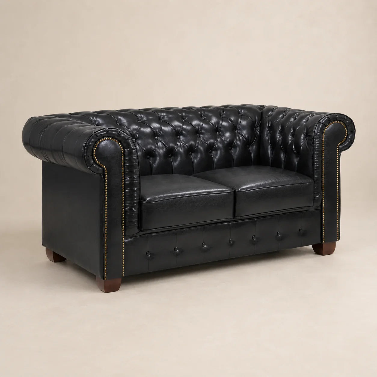 Black leather Chesterfield sofa with tufted back, rolled arms, and nailhead trim