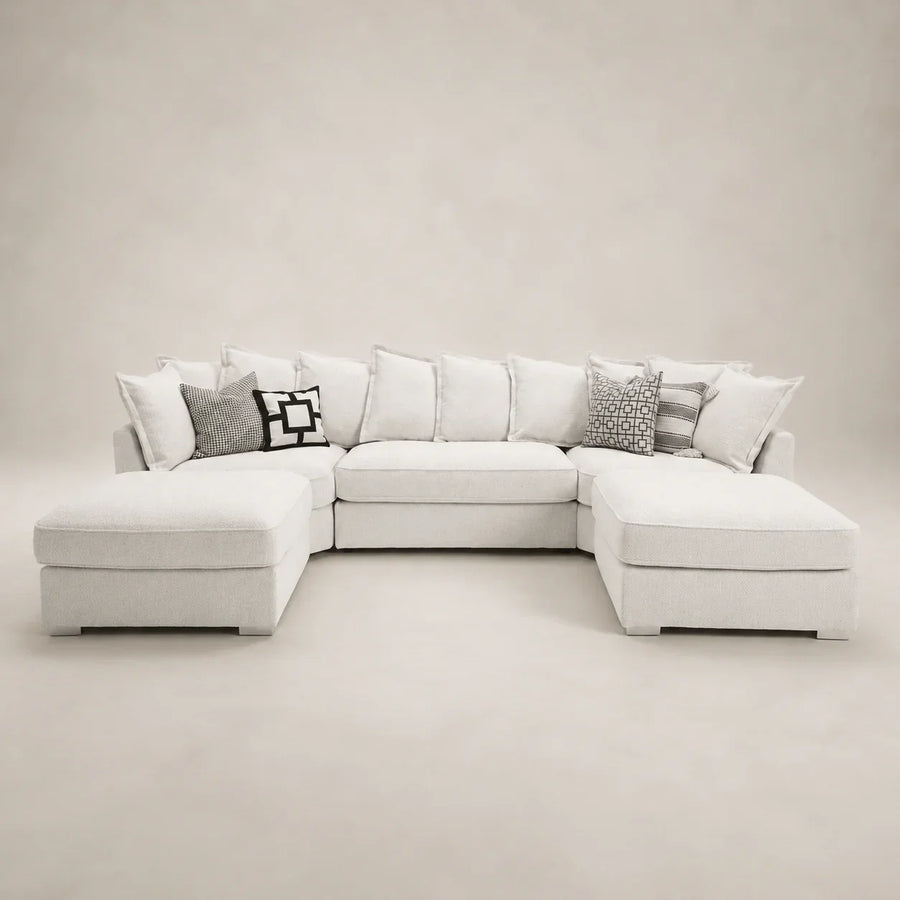 Luxury white sectional sofa with chaise lounges and patterned throw pillows, perfect for modern living rooms.