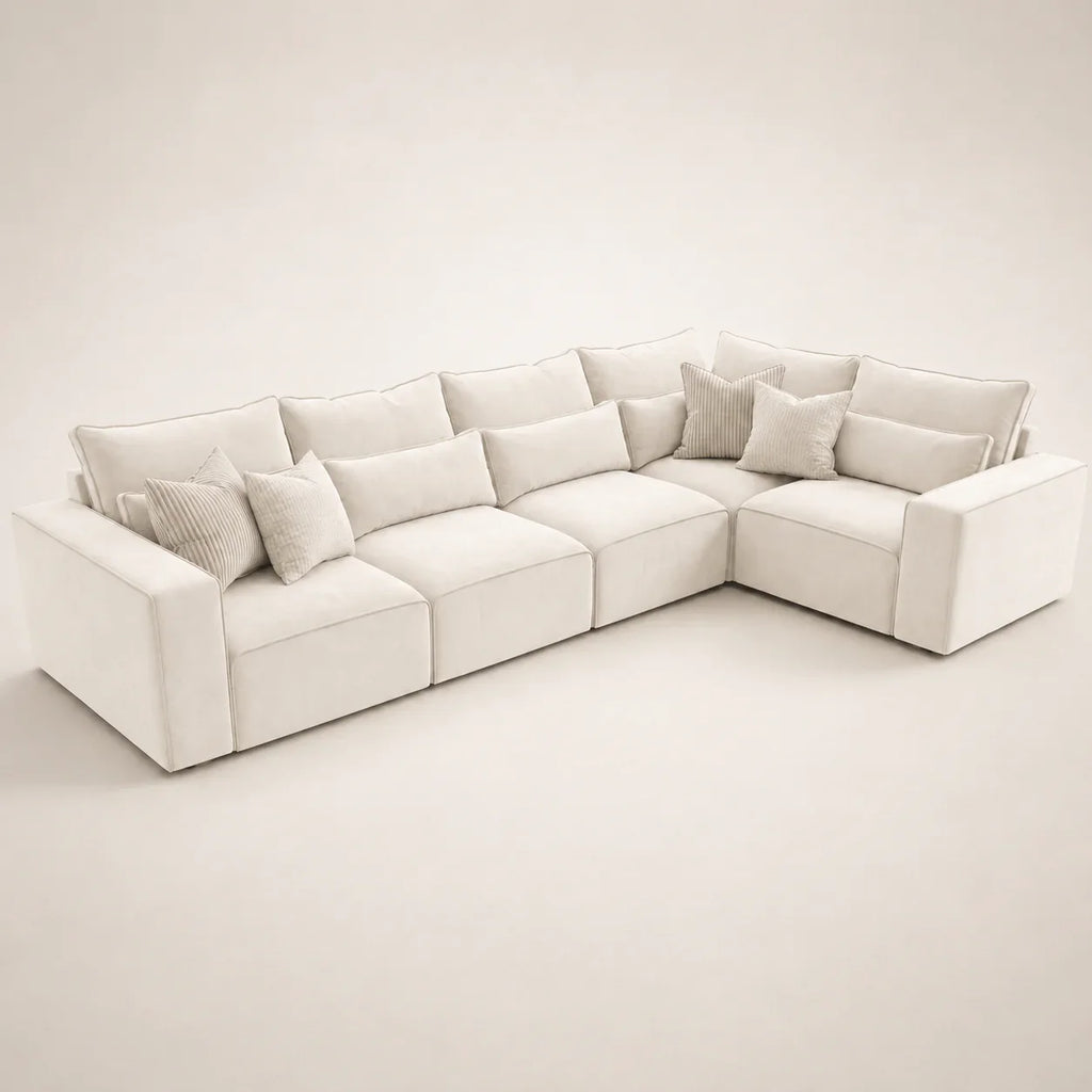 Luxury white sectional sofa with plush cushions and throw pillows, modern living room furniture