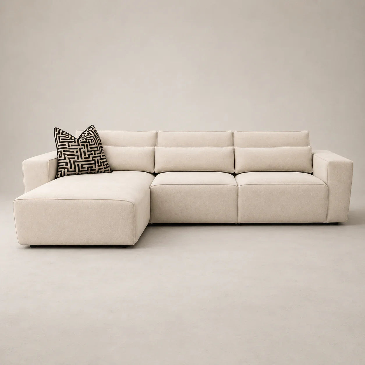 Modern beige sectional sofa with chaise and geometric pillow, luxury living room furniture