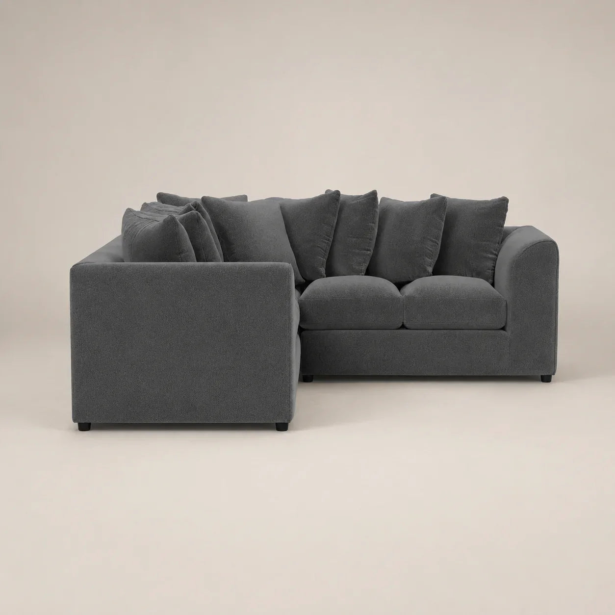 Dark gray sectional sofa with plush cushions, modern design for luxury living spaces