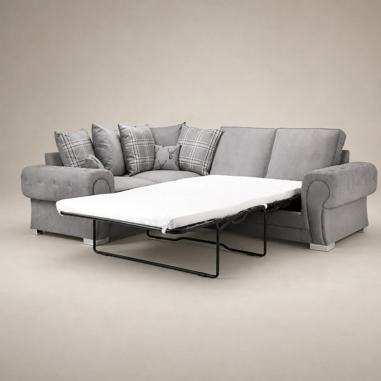 Grey fabric sofa bed with pull-out mattress and plaid cushions, ideal for living room comfort.