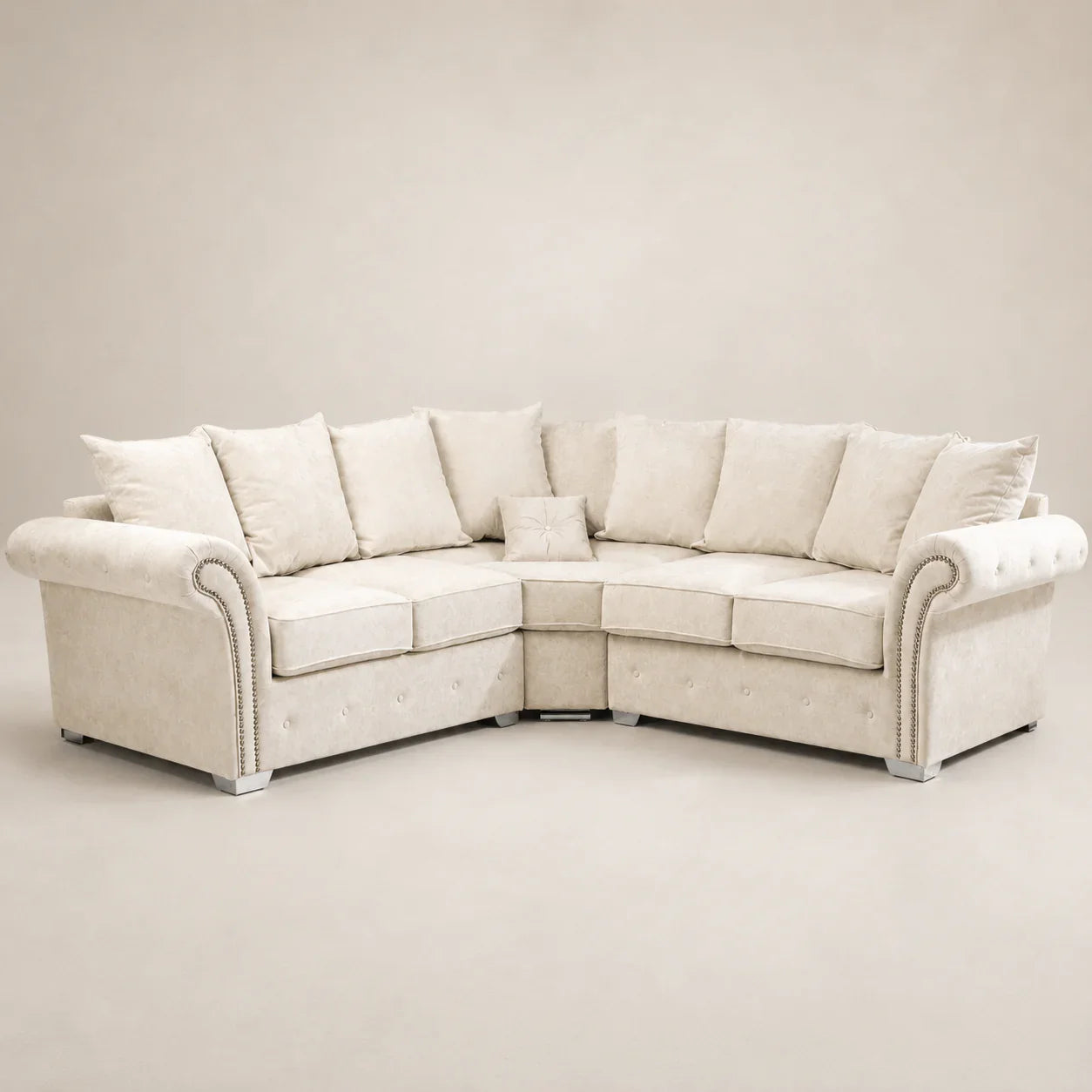 Cream luxury corner sofa with rolled arms, nailhead trim, and plush cushions for modern living rooms