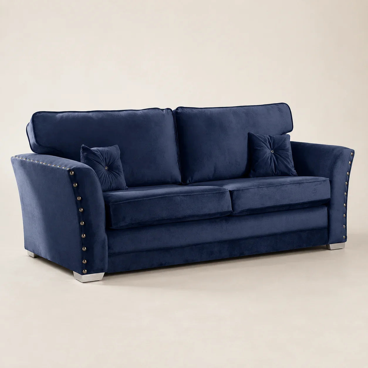 Navy blue velvet sofa with tufted pillows and studded arms, luxury living room furniture