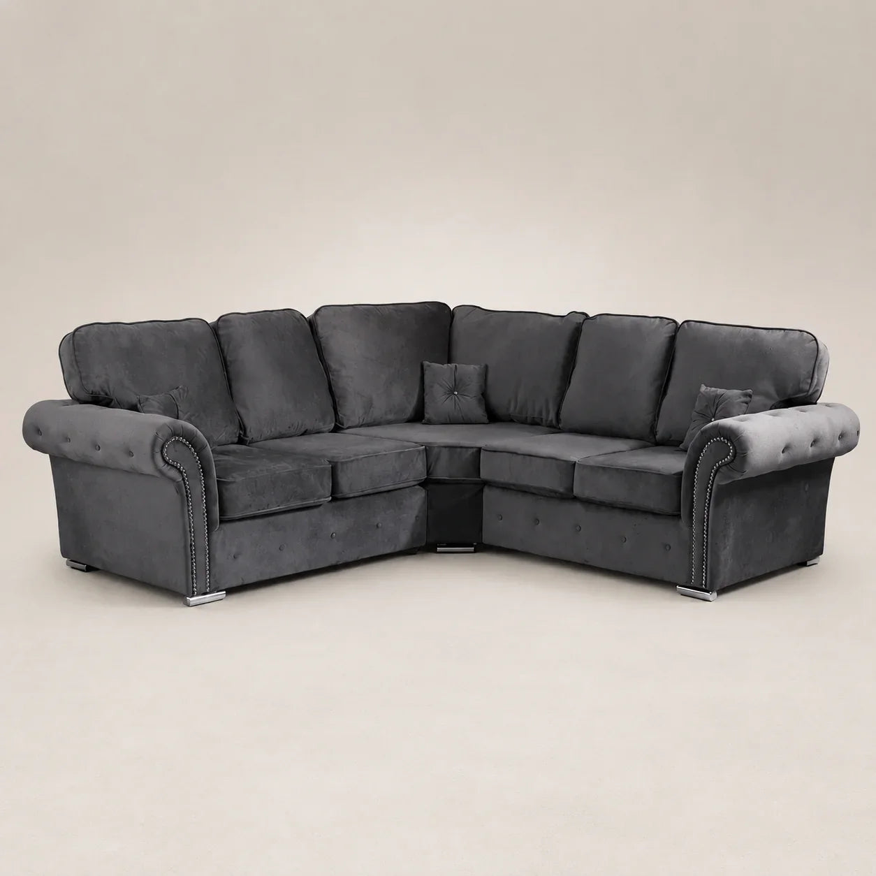 Luxury dark grey velvet corner sofa with tufted arms and nailhead trim, ideal for modern living rooms