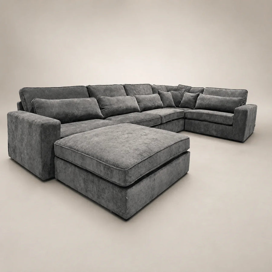 Luxury grey sectional sofa with chaise and ottoman, perfect for modern living rooms