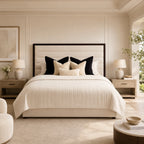 Luxury upholstered bed with tufted headboard, neutral bedding, and matching nightstands in a serene bedroom.