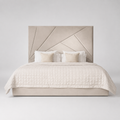 Luxury beige upholstered bed with geometric headboard, quilted duvet, and accent pillows for modern bedroom